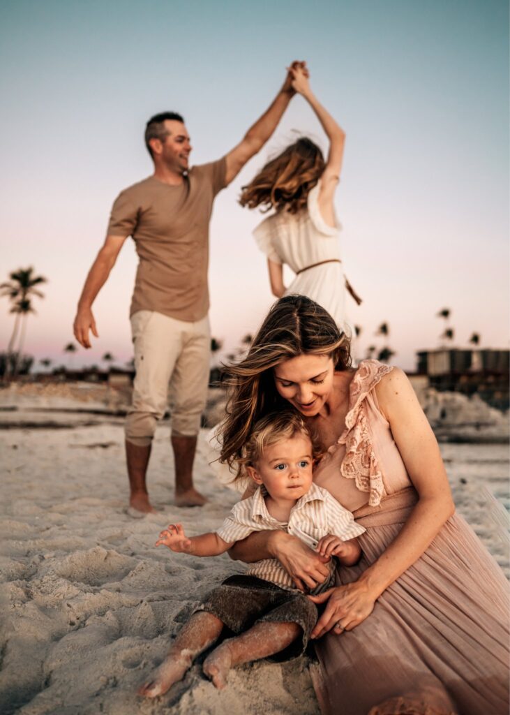 dad-spinning-daughter-at-sunset-on-the-beach