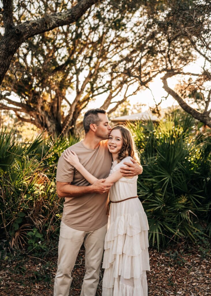 dad-kissing-daughter-during-golden-hour-family-photoshoot-cape-corall-florida