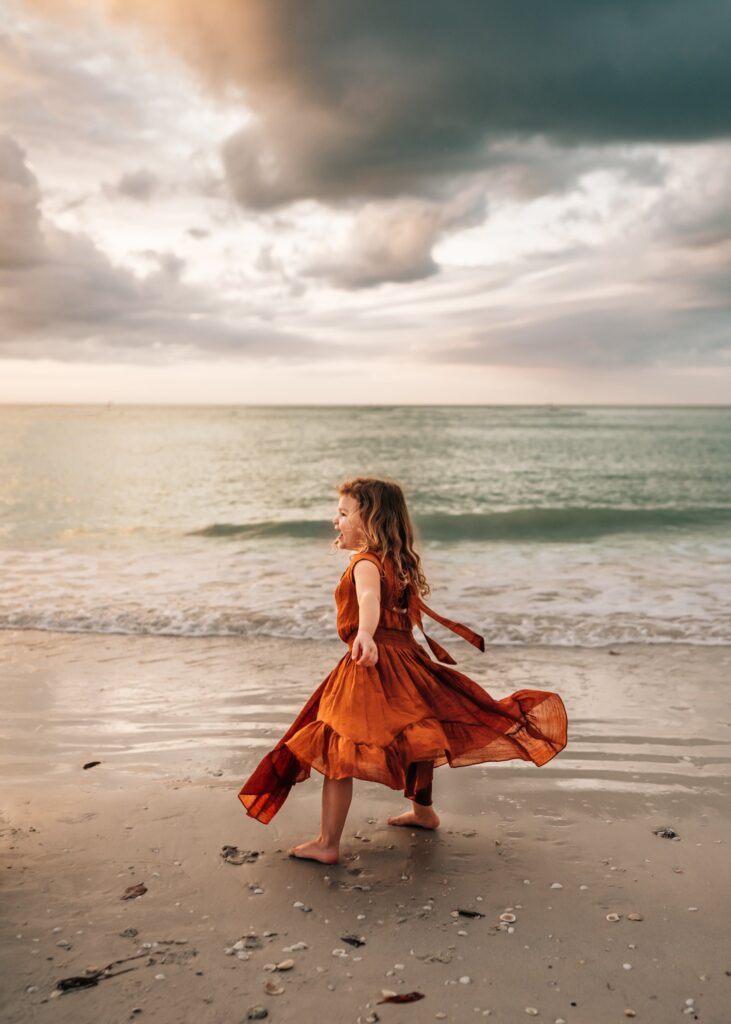 little-girl-spinning-in-dress-on-the-beach-in-marco-island-florida
