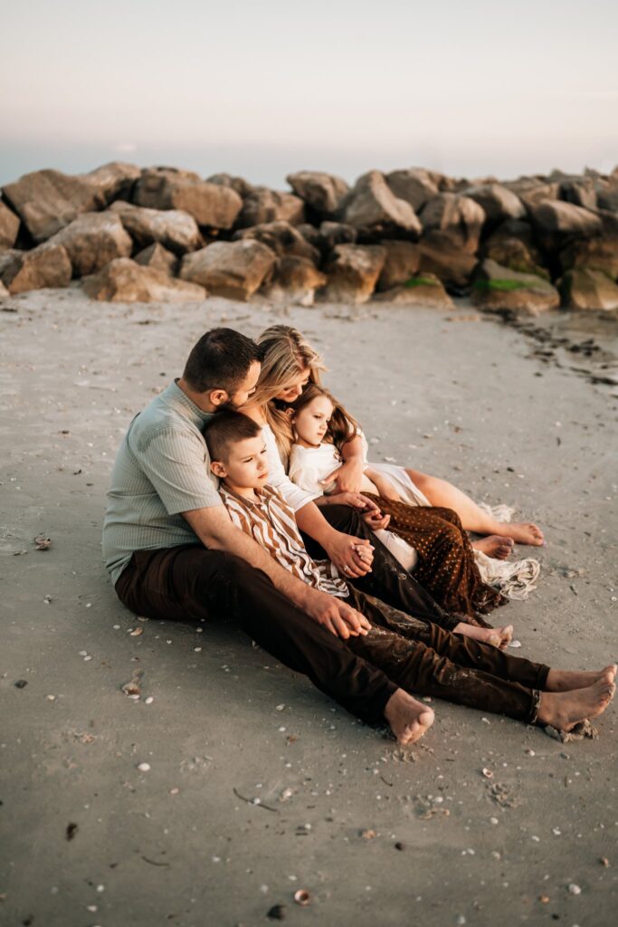 family-watching-sunset-during-beach-photoshoot