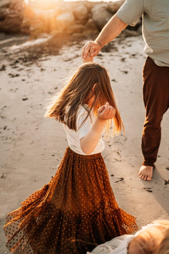 mother-and-daughter-dancing-on-beach