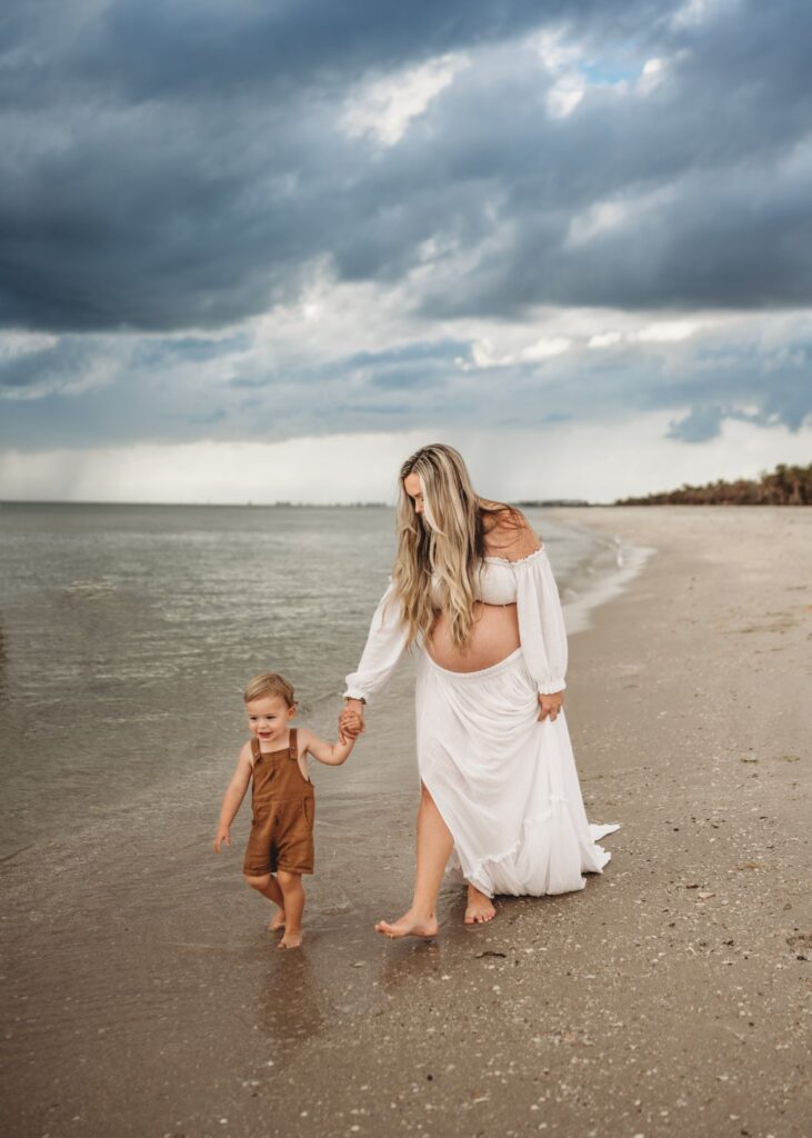 mother-and-son-walking-on-the-beach-sunset