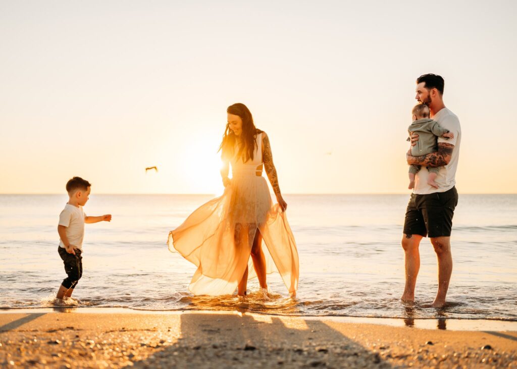family-playing-on-bonita-beach-sunset